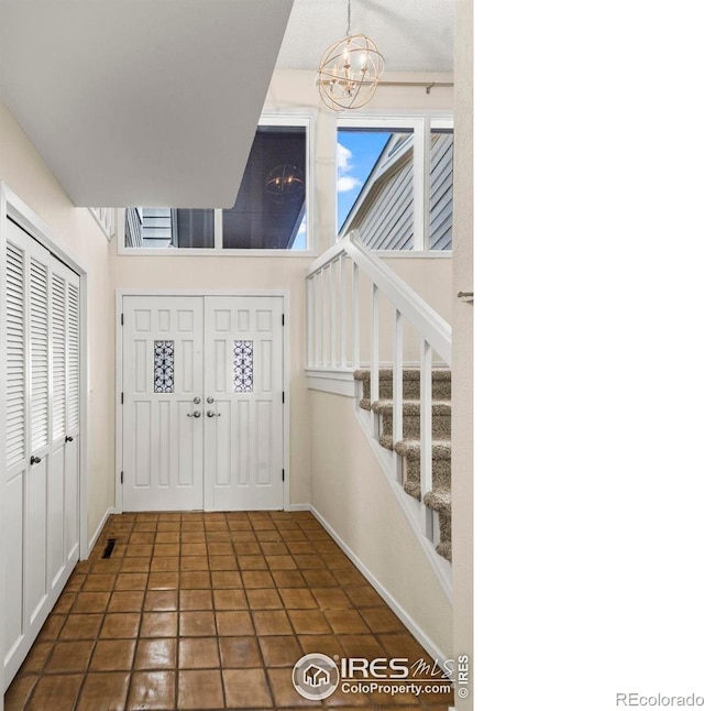 4950 Sundance Sq, Boulder, CO 80301 - foyer entrance with a chandelier, stairway, and baseboards