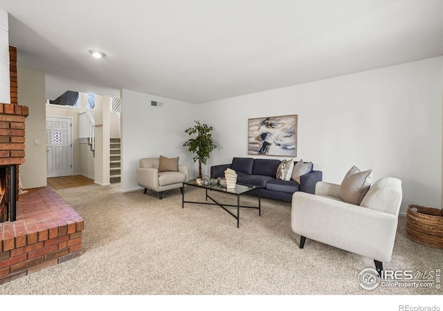 4950 Sundance Sq, Boulder, CO 80301 - living room featuring carpet, stairs, a brick fireplace, and baseboards