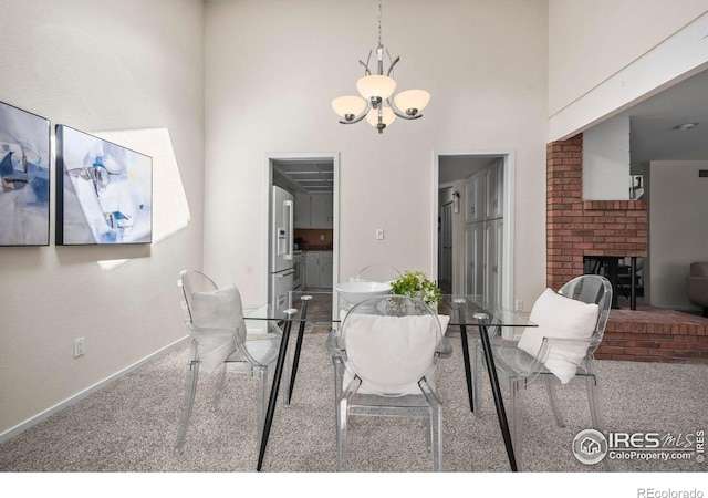4950 Sundance Sq, Boulder, CO 80301 - dining room with carpet floors, a chandelier, a brick fireplace, baseboards, and a high ceiling