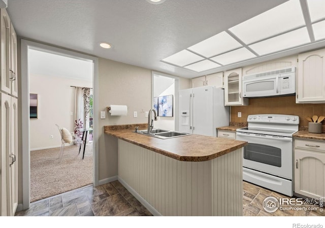 4950 Sundance Sq, Boulder, CO 80301 - kitchen featuring white appliances, a sink, a peninsula, baseboards, and glass insert cabinets