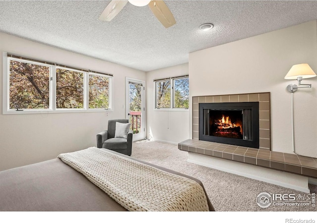 4950 Sundance Sq, Boulder, CO 80301 - carpeted bedroom featuring access to exterior, a fireplace, a textured ceiling, and ceiling fan
