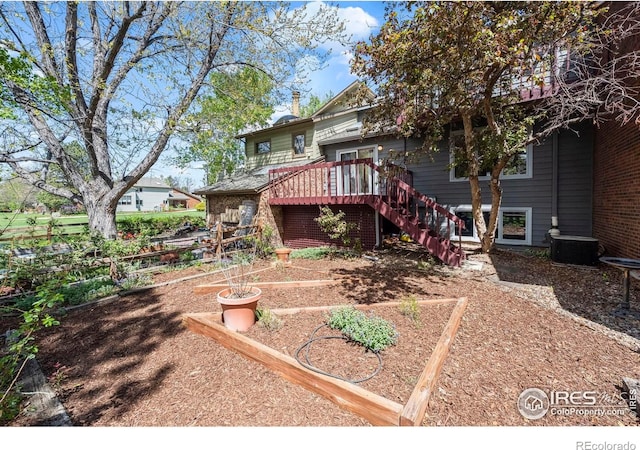 4950 Sundance Sq, Boulder, CO 80301 - back of property featuring stairway, a vegetable garden, and a wooden deck