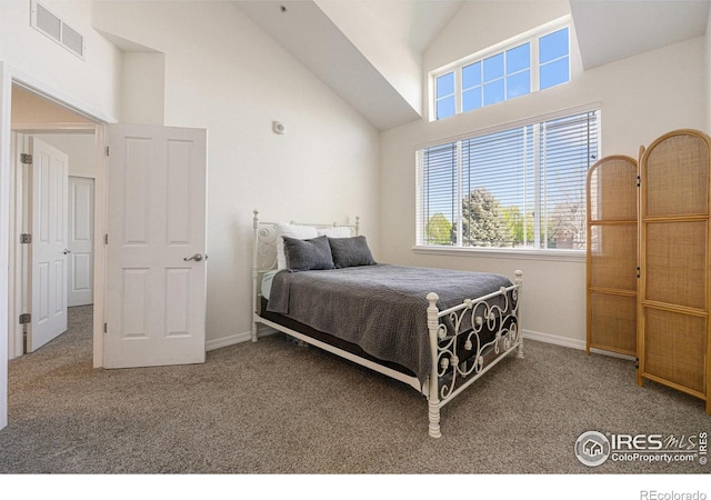 carpeted bedroom with visible vents, baseboards, and high vaulted ceiling