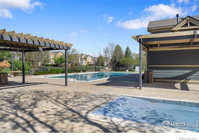 community pool with a patio and fence
