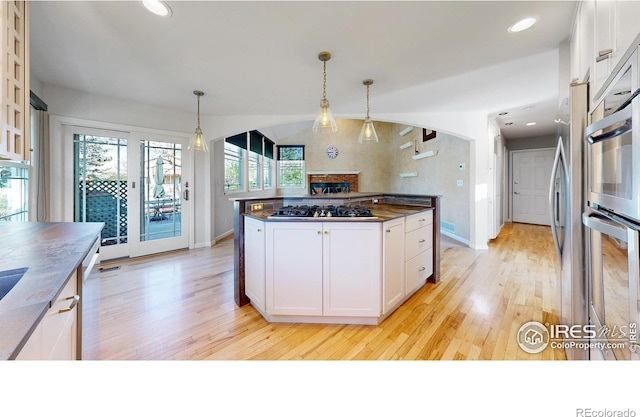 kitchen featuring a wealth of natural light, light wood-style flooring, and black gas cooktop