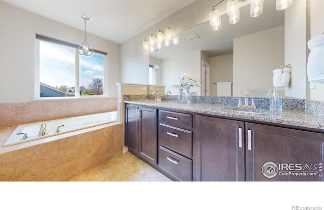 full bathroom with a sink, double vanity, tile patterned floors, visible vents, and a bath