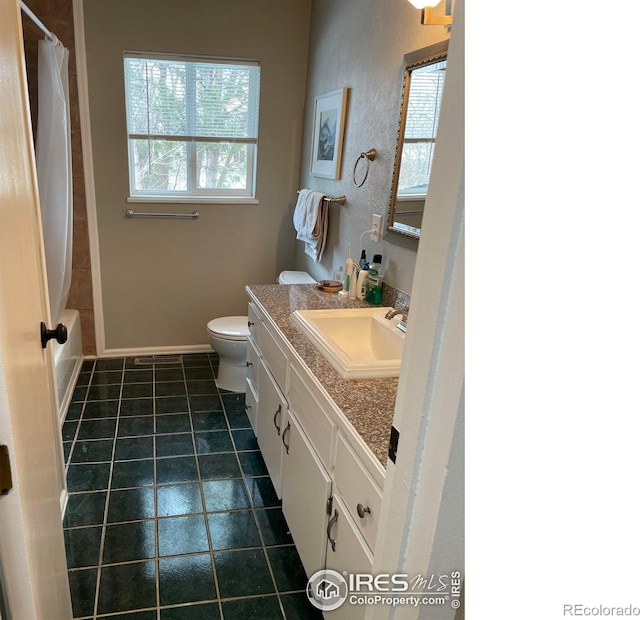 1208 Briarwood Rd, Fort Collins, CO 80521 - full bath with vanity, healthy amount of natural light, toilet, and tile patterned floors
