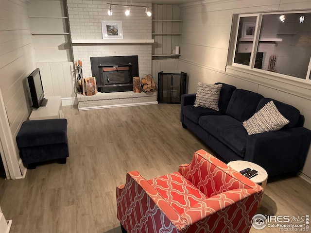 1208 Briarwood Rd, Fort Collins, CO 80521 - living area with wood finished floors and a brick fireplace