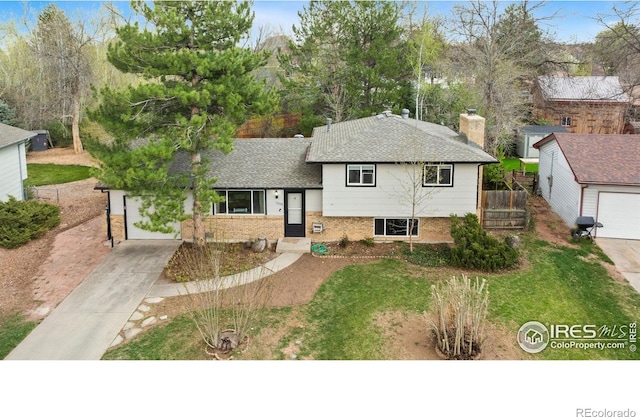 1208 Briarwood Rd, Fort Collins, CO 80521 - split level home featuring concrete driveway, brick siding, and a shingled roof