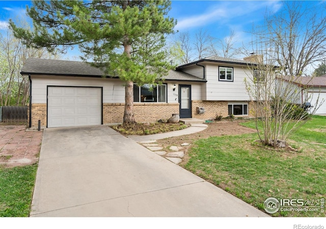 1208 Briarwood Rd, Fort Collins, CO 80521 - split level home featuring brick siding, an attached garage, concrete driveway, and a chimney