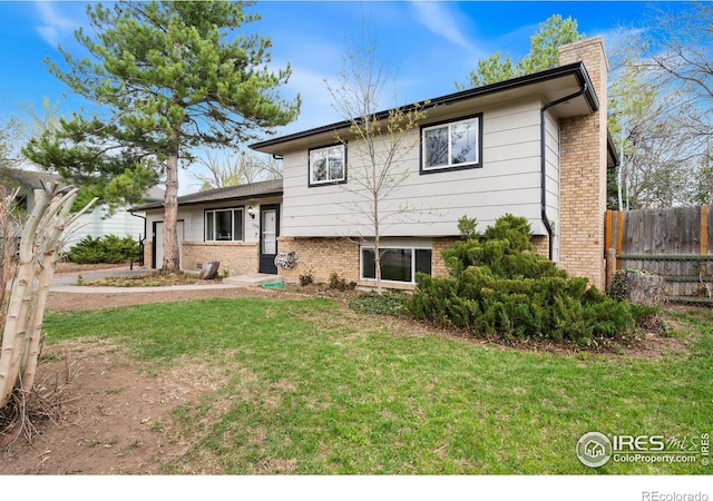 1208 Briarwood Rd, Fort Collins, CO 80521 - view of front of home featuring brick siding and a chimney