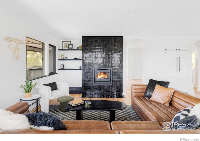 319 S Peak Rd, Boulder, CO 80302 - living area featuring arched walkways, a fireplace, and wood finished floors