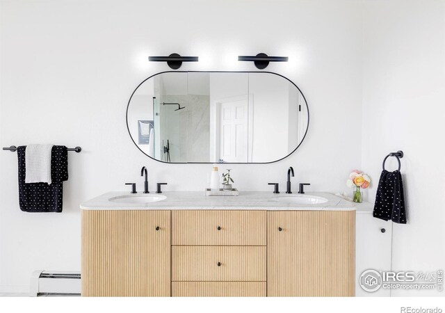 319 S Peak Rd, Boulder, CO 80302 - full bath with double vanity, walk in shower, a baseboard heating unit, and a sink