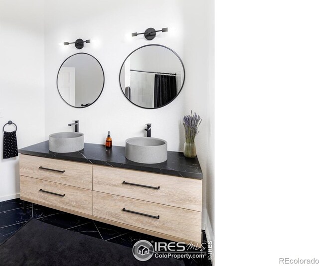 319 S Peak Rd, Boulder, CO 80302 - bathroom featuring double vanity, baseboards, and a sink