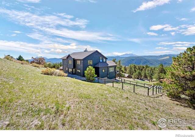 319 S Peak Rd, Boulder, CO 80302 - exterior space featuring a lawn, a mountain view, and fence