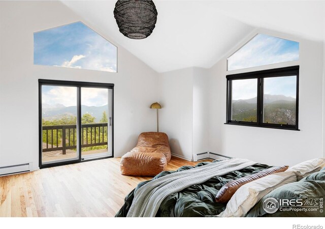 319 S Peak Rd, Boulder, CO 80302 - bedroom with access to exterior, wood finished floors, and multiple windows