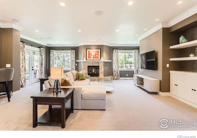 living room with recessed lighting, ornamental molding, light carpet, and a fireplace