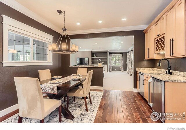 dining area featuring dark wood-style flooring, baseboards, a chandelier, and ornamental molding