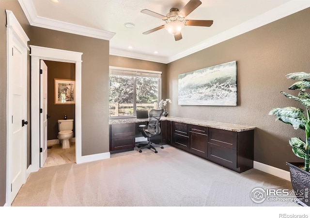 office space featuring crown molding, a ceiling fan, baseboards, and light colored carpet