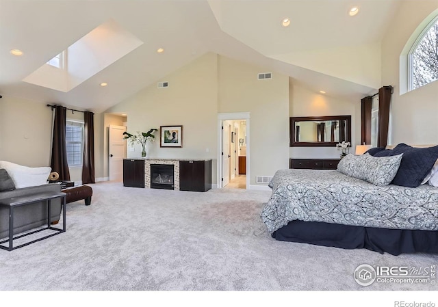bedroom featuring recessed lighting, high vaulted ceiling, carpet, and a fireplace
