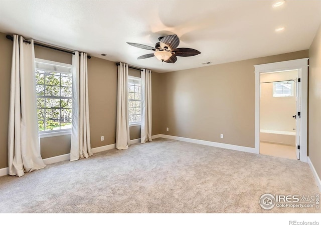 unfurnished bedroom with baseboards, carpet, and multiple windows