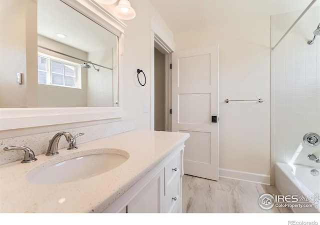 bathroom featuring vanity, marble finish floor, and shower / washtub combination