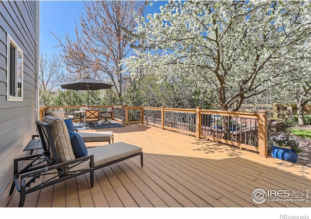 wooden terrace with outdoor dining space