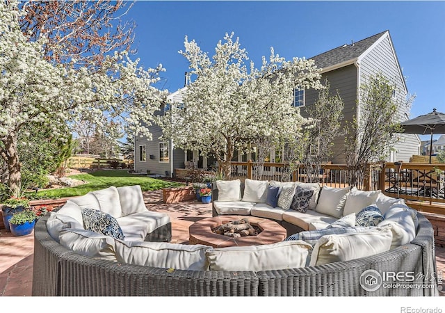 view of patio / terrace with an outdoor living space with a fire pit