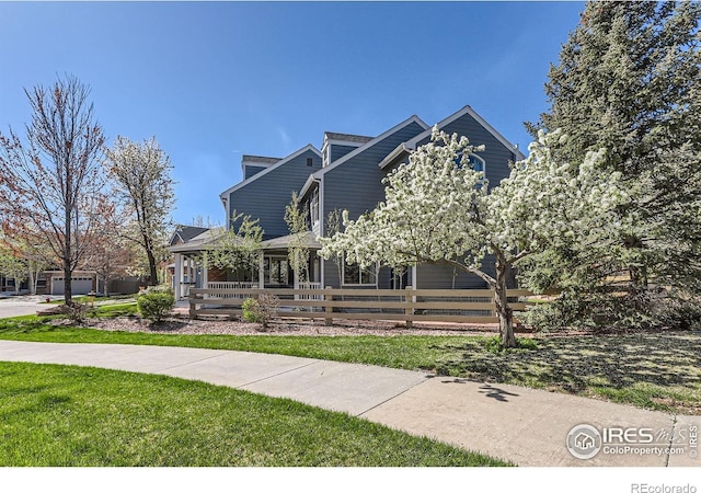 view of front facade with a fenced front yard, a porch, and a front yard