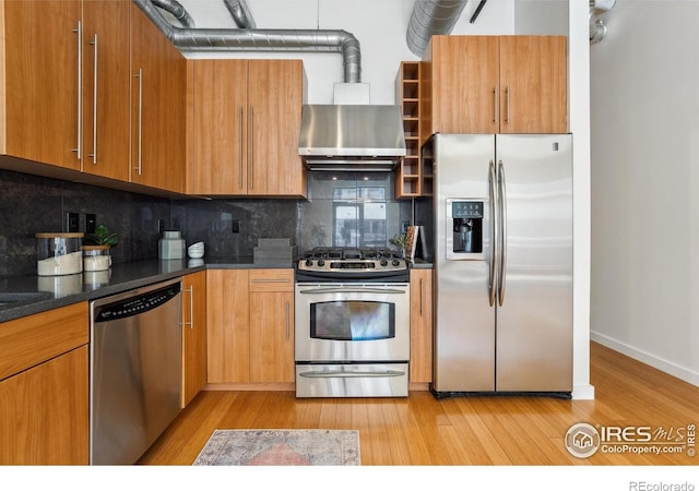 1360 Walnut St Unit 211, Boulder, CO 80302 - kitchen with stainless steel appliances, brown cabinetry, tasteful backsplash, and light wood-type flooring