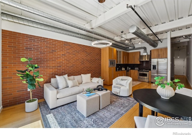 1360 Walnut St Unit 211, Boulder, CO 80302 - living area with brick wall and light wood-style flooring