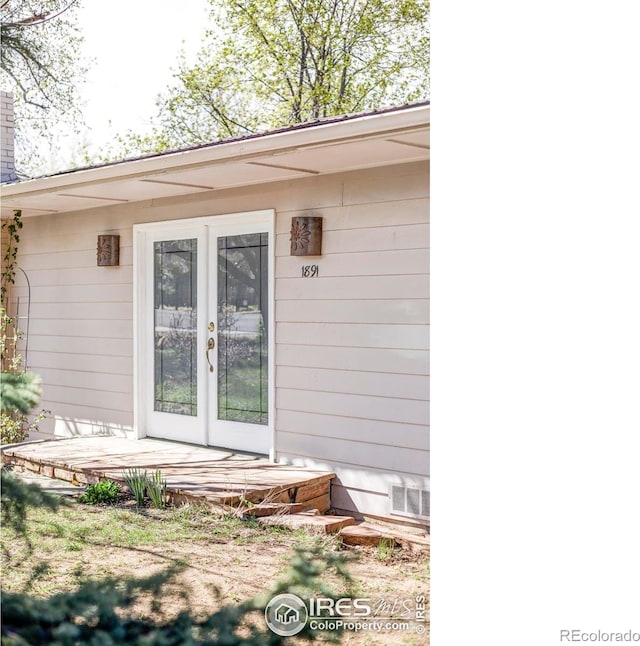 doorway to property featuring french doors and a chimney