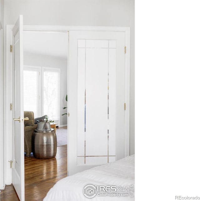 bedroom featuring wood finished floors and a closet