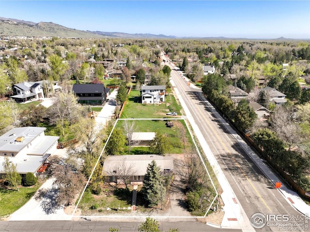 aerial view of residential area featuring property parcel outlined and mountains