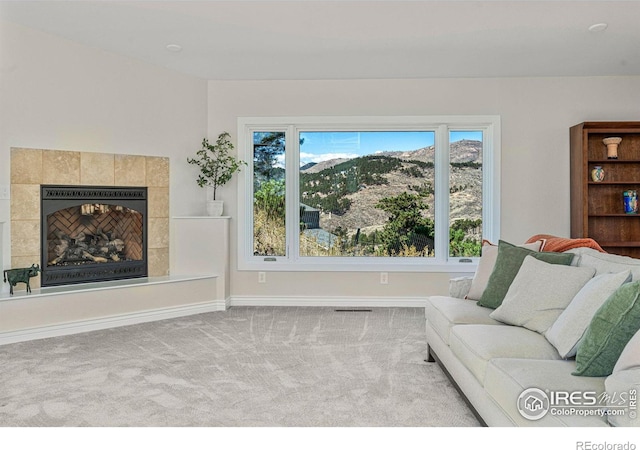 319 Camino Bosque, Boulder, CO 80302 - carpeted living room with baseboards and a tiled fireplace