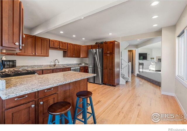 319 Camino Bosque, Boulder, CO 80302 - kitchen featuring appliances with stainless steel finishes, a sink, a peninsula, light wood-type flooring, and recessed lighting
