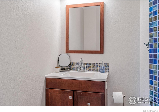 319 Camino Bosque, Boulder, CO 80302 - bathroom featuring backsplash, vanity, and a textured wall
