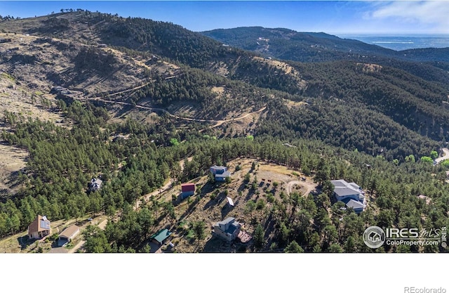 319 Camino Bosque, Boulder, CO 80302 - aerial overview of property's location featuring a mountainous background and a forest