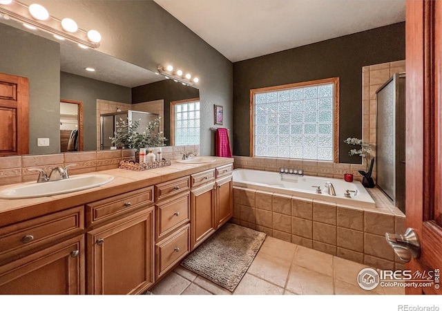 11669 Montgomery Cir, Longmont, CO 80504 - bathroom featuring tile patterned flooring, a shower stall, a sink, and a garden tub