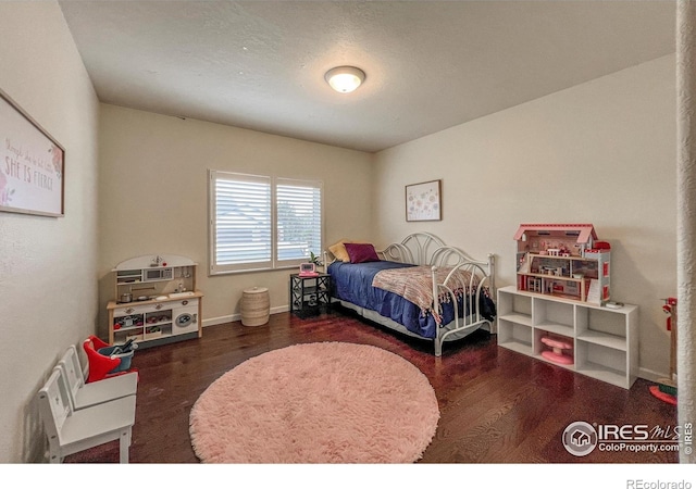 11669 Montgomery Cir, Longmont, CO 80504 - bedroom featuring baseboards and wood finished floors