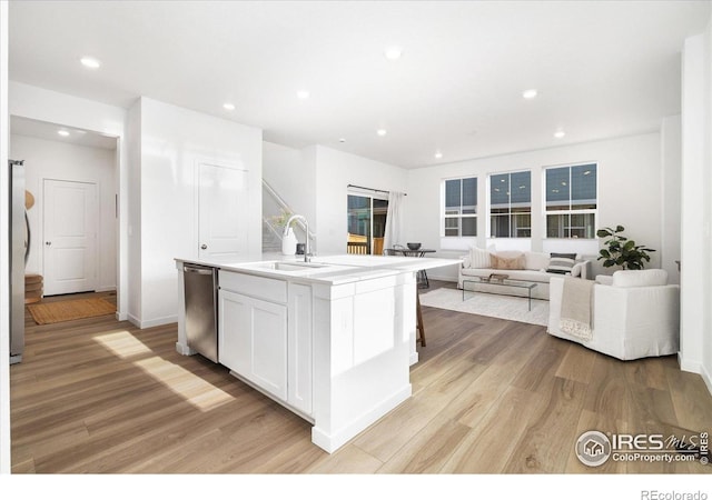 2260 Crescent Cir, Erie, CO 80026 - kitchen with a sink, stainless steel appliances, light wood-type flooring, white cabinetry, and recessed lighting