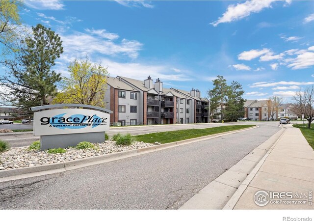 6385 Oak St Unit 301, Arvada, CO 80004 - view of asphalt road with curbs, a residential view, and sidewalks