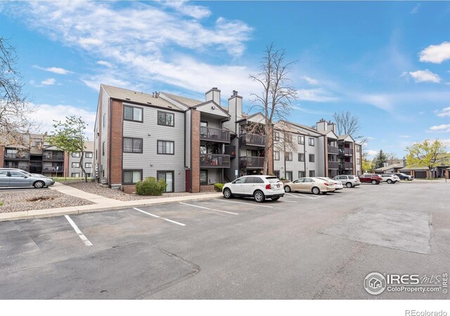 6385 Oak St Unit 301, Arvada, CO 80004 - view of property with uncovered parking and a residential view