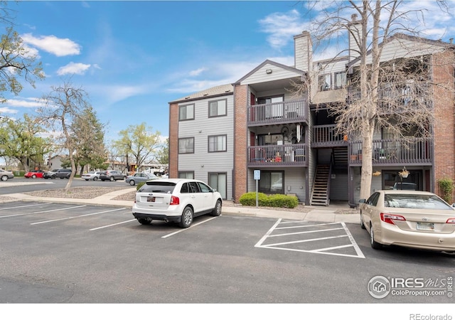 6385 Oak St Unit 301, Arvada, CO 80004 - view of property featuring uncovered parking and stairs