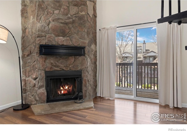 6385 Oak St Unit 301, Arvada, CO 80004 - unfurnished living room featuring a fireplace and wood finished floors