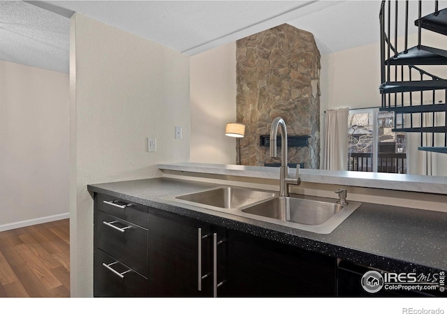 6385 Oak St Unit 301, Arvada, CO 80004 - kitchen with wood finished floors, dark cabinetry, and dark countertops