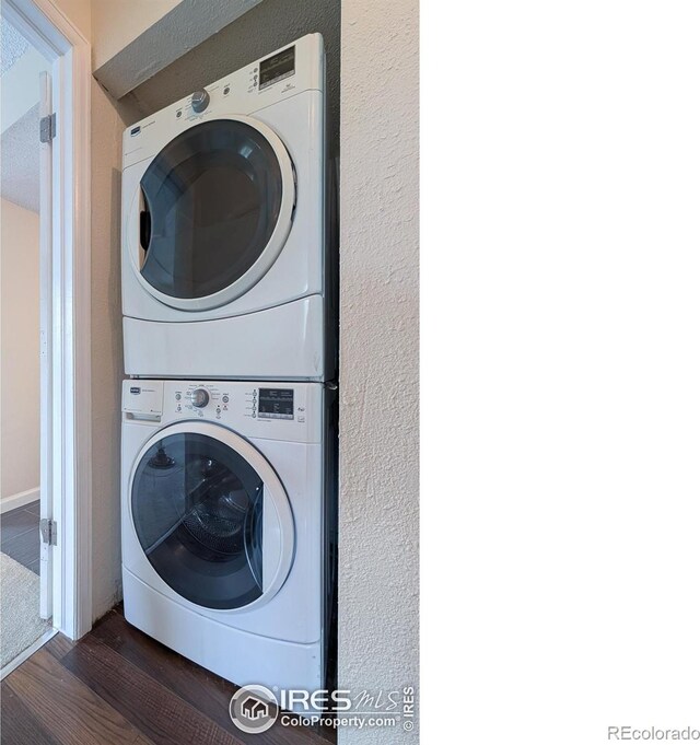 6385 Oak St Unit 301, Arvada, CO 80004 - laundry room featuring stacked washer and clothes dryer and wood finished floors