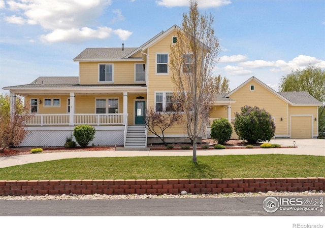 3530 Willow Rd, Frederick, CO 80504 - view of front of home with covered porch, an attached garage, concrete driveway, and a front lawn