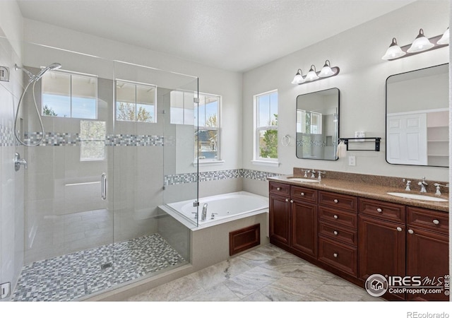 3530 Willow Rd, Frederick, CO 80504 - full bath with a sink, double vanity, a stall shower, and a garden tub