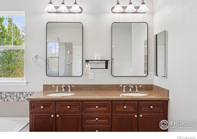 3530 Willow Rd, Frederick, CO 80504 - bathroom featuring a sink, a tub to relax in, and double vanity